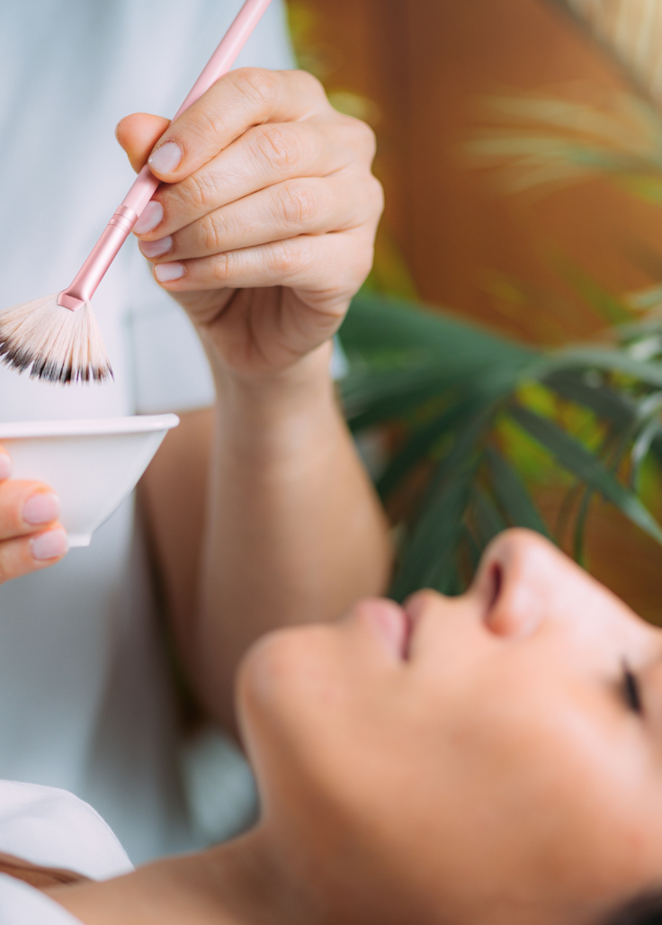 Female receiving chemical peel treatment